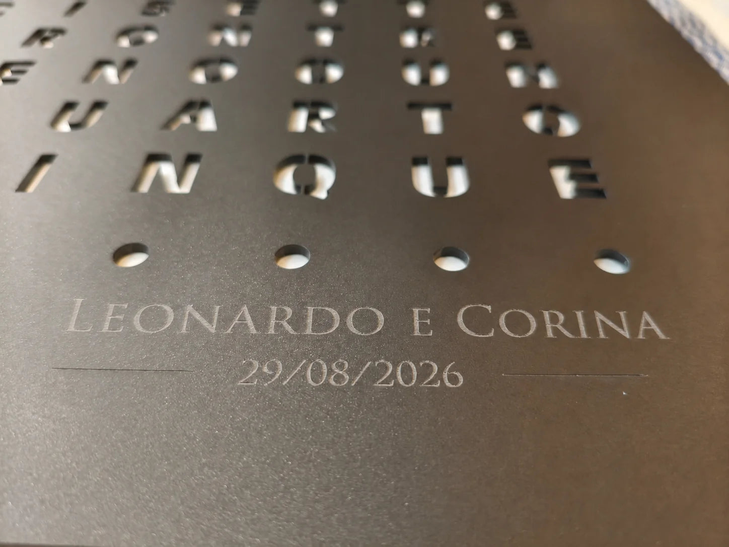 Close-up of a personalised engraving — a name and date — on a LumosClock