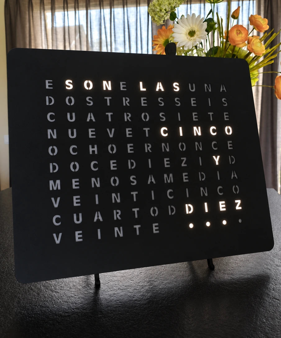 LumosClock Spanish edition, lit on a dark kitchen counter in the evening