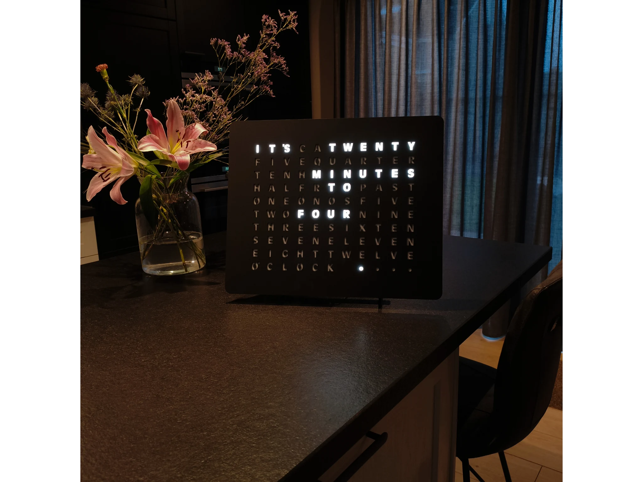 LumosClock on a wooden console in a living room at dusk